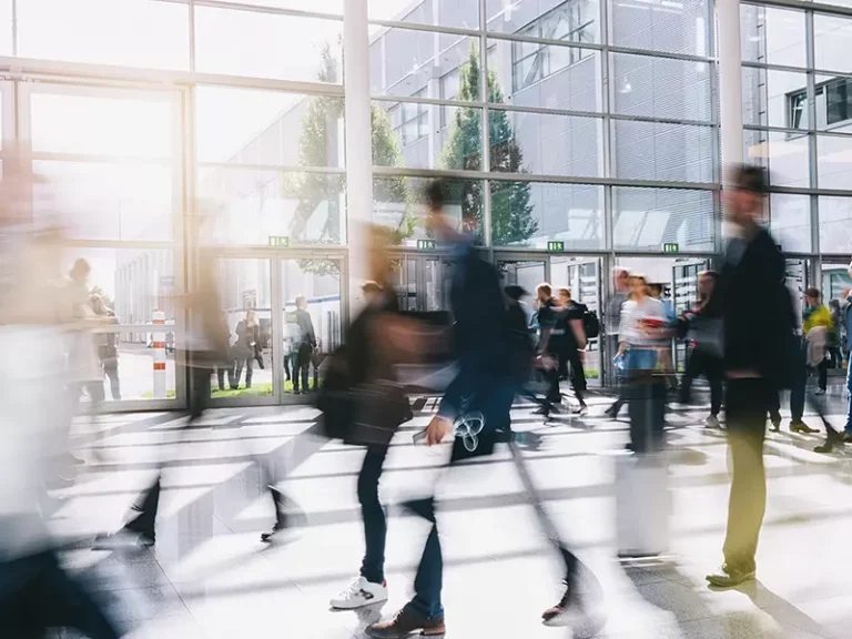 People in a rush office glass sunshine